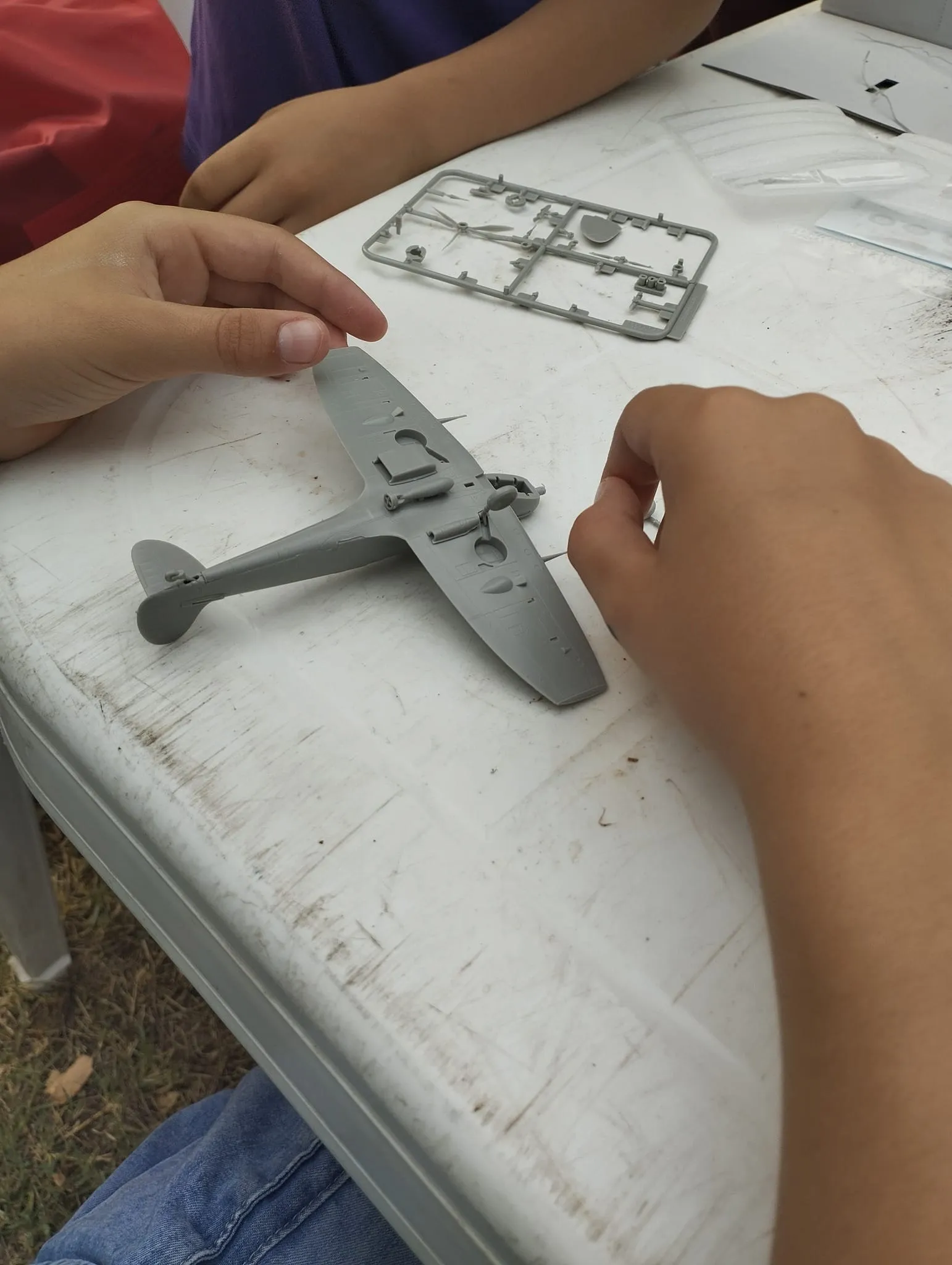 Kids making plastic airplane models