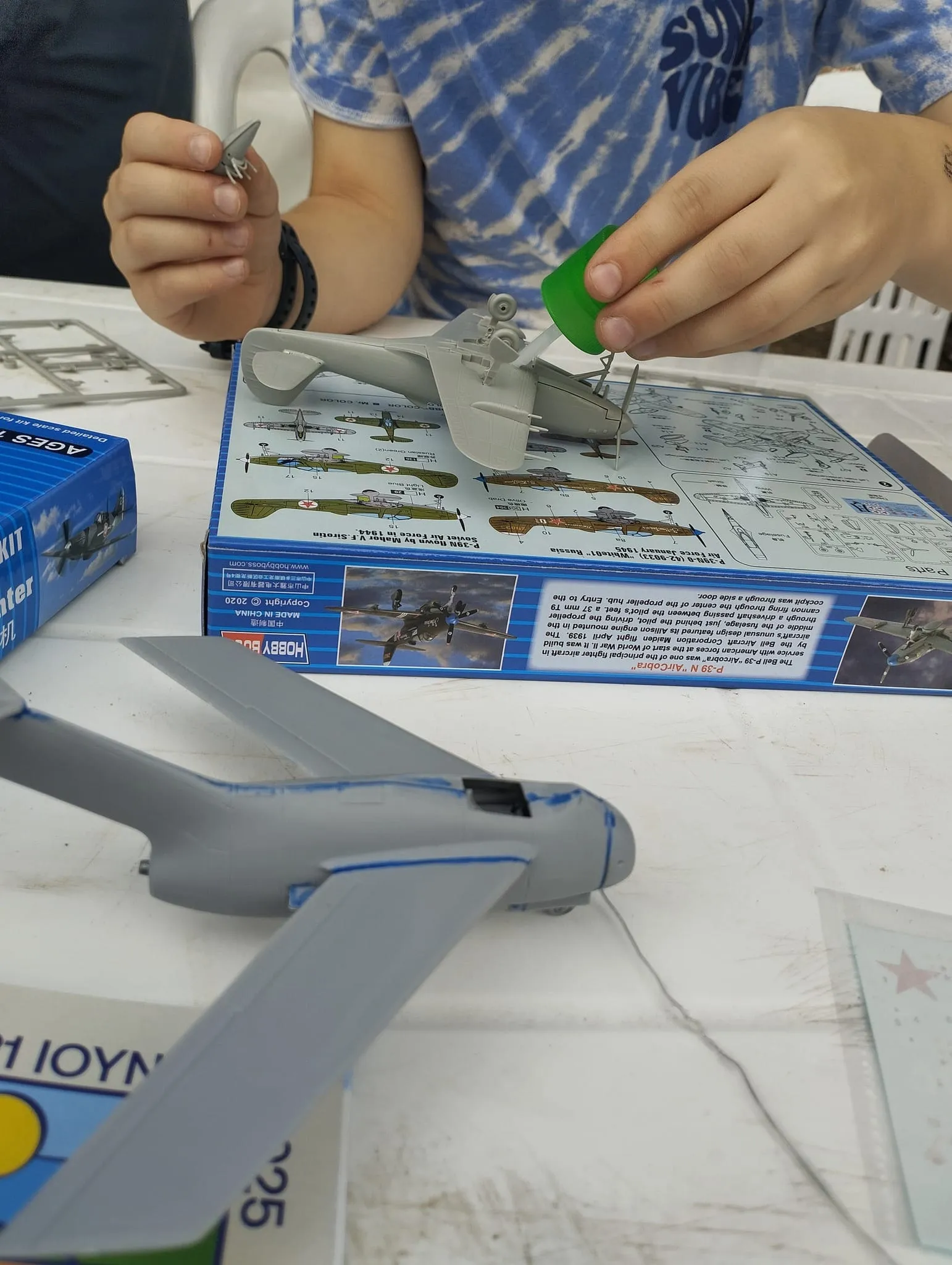 Kids making plastic airplane models